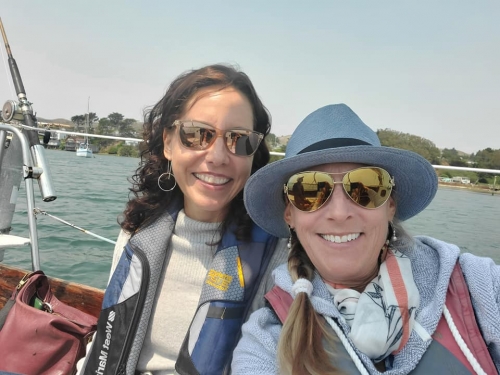 Two sisters on a boat. My older sister is wearing the hat.